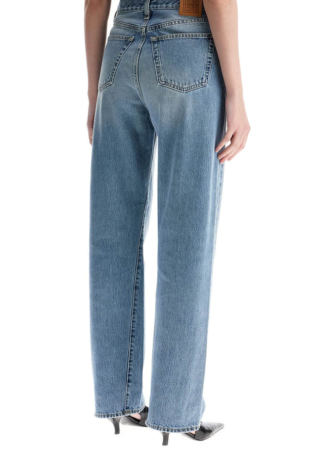 Toteme wide leg organic cotton jeans in worn blue with twisted seams