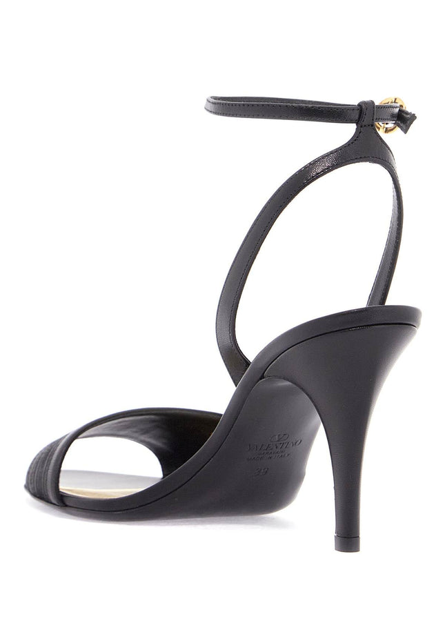 Valentino Garavani black goat leather sandals with gold buckle and stiletto heel